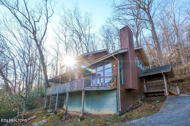 view of side of home with a deck