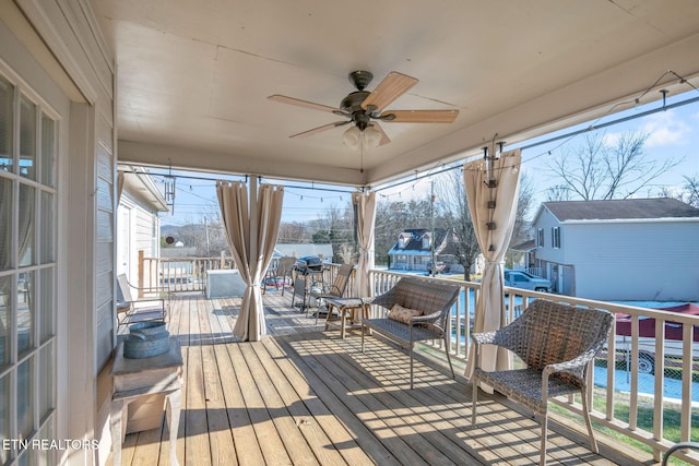 wooden terrace featuring ceiling fan