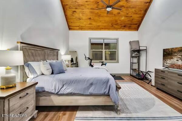 bedroom featuring high vaulted ceiling, dark hardwood / wood-style flooring, and wood ceiling