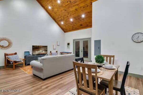 living room featuring electric panel, light hardwood / wood-style flooring, wood ceiling, high vaulted ceiling, and french doors