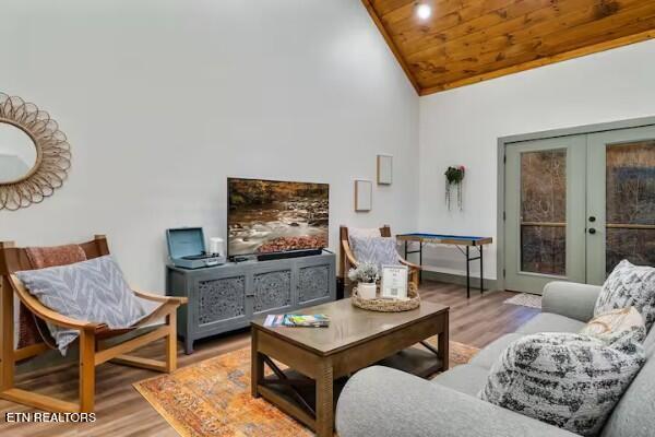 living room featuring wood ceiling, light hardwood / wood-style floors, french doors, and high vaulted ceiling