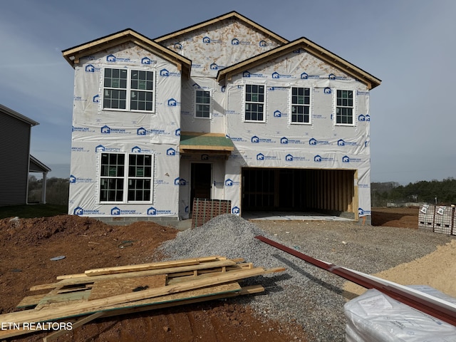 unfinished property with a garage and driveway