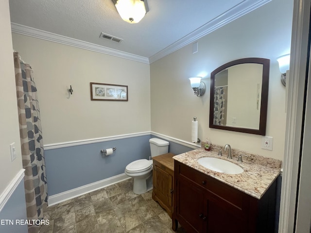 bathroom featuring ornamental molding, toilet, a textured ceiling, and vanity