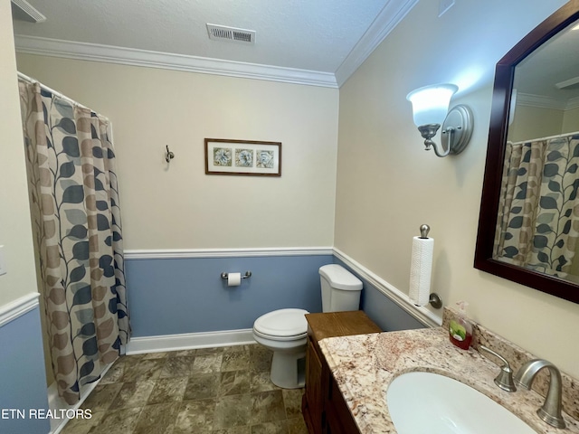 bathroom with ornamental molding, curtained shower, vanity, and toilet