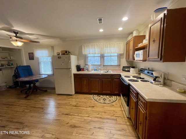 kitchen featuring sink, white appliances, ornamental molding, ceiling fan, and light hardwood / wood-style floors