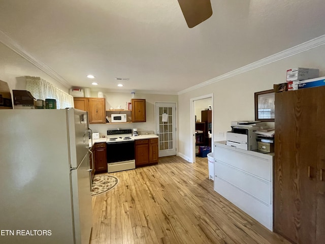 kitchen featuring white appliances, ornamental molding, and light hardwood / wood-style floors