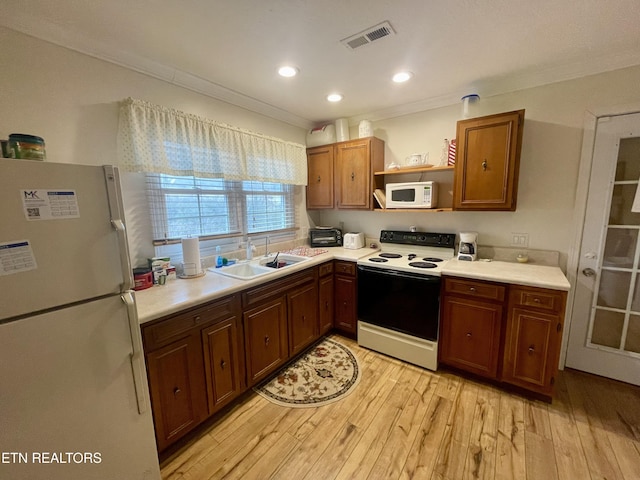 kitchen with white appliances, ornamental molding, light hardwood / wood-style floors, and sink