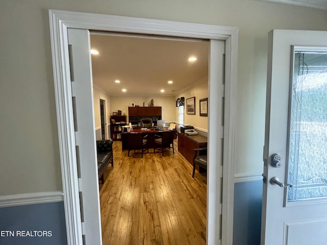 interior space featuring crown molding and light hardwood / wood-style floors