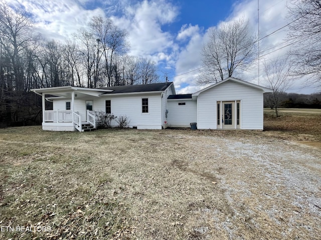 back of property with a porch