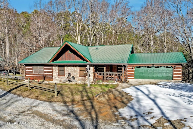 log-style house featuring a garage