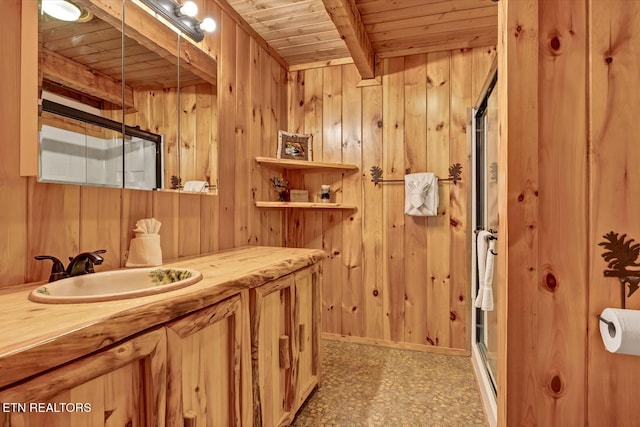 bathroom with beam ceiling, vanity, wooden walls, and wooden ceiling