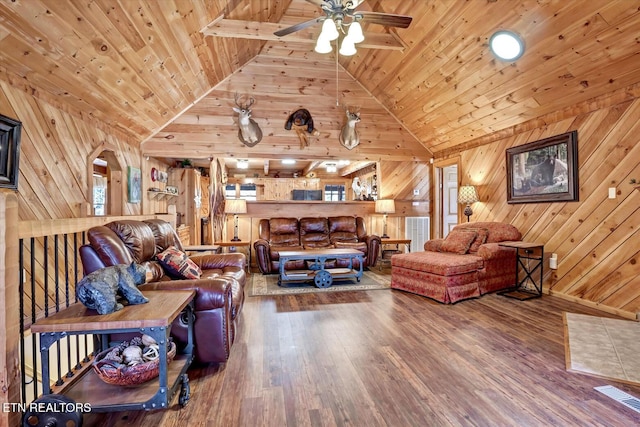 living room featuring ceiling fan, wood ceiling, wooden walls, and hardwood / wood-style flooring