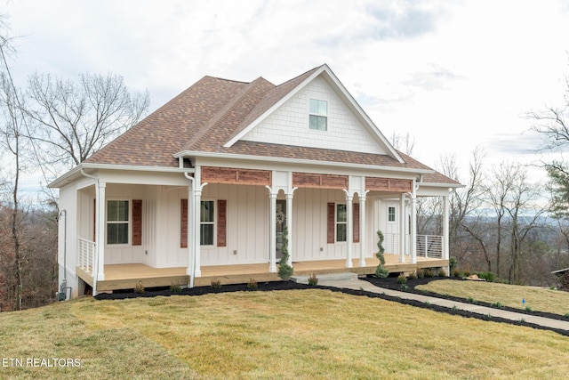 view of front of property with a front yard and covered porch