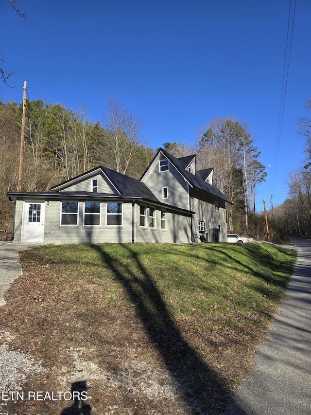 view of home's exterior with a lawn