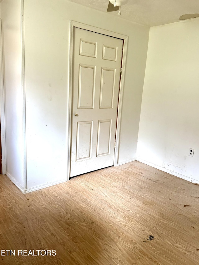 unfurnished room with ceiling fan and light hardwood / wood-style flooring