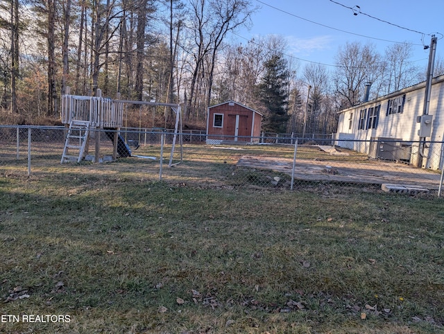 view of yard featuring a storage shed and a playground