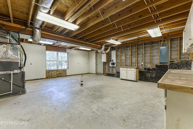 basement with electric panel and heating unit