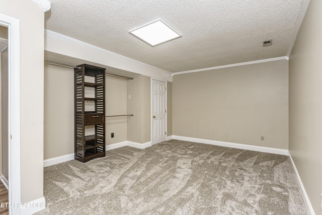 basement featuring carpet floors, ornamental molding, and a textured ceiling