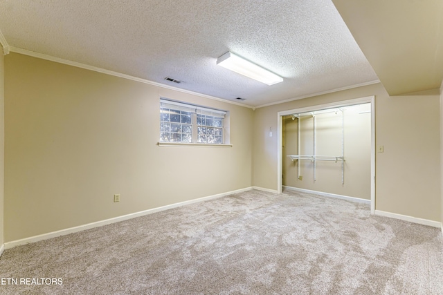 interior space with ornamental molding, light carpet, and a textured ceiling