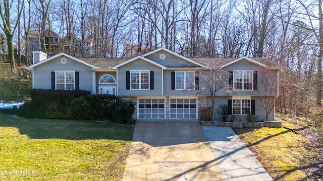 view of front of house with a garage and a front yard