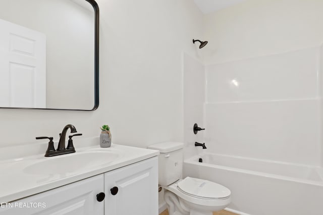 full bathroom with toilet, vanity, and  shower combination