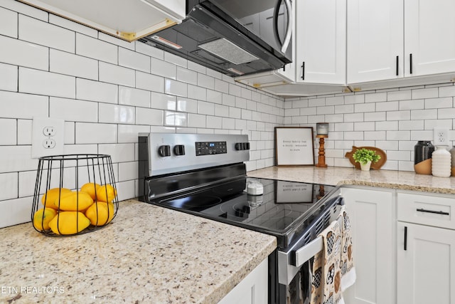 kitchen with decorative backsplash, stainless steel electric stove, and white cabinetry