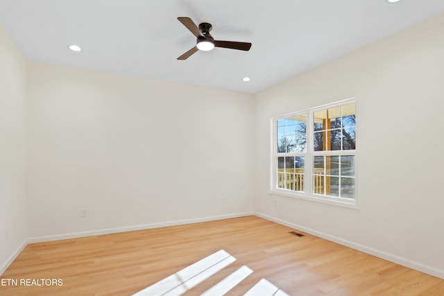 spare room featuring light wood-type flooring and ceiling fan