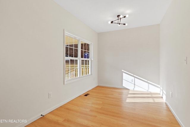 unfurnished dining area with a notable chandelier and hardwood / wood-style floors