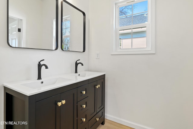 bathroom with hardwood / wood-style floors and vanity