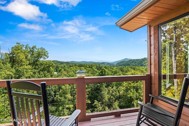 wooden deck featuring a mountain view