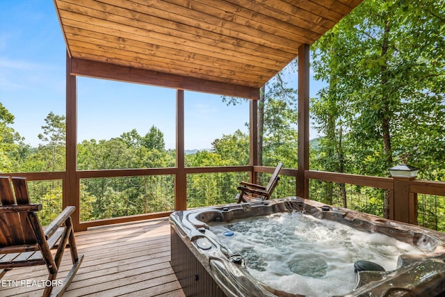 wooden terrace featuring an outdoor hot tub