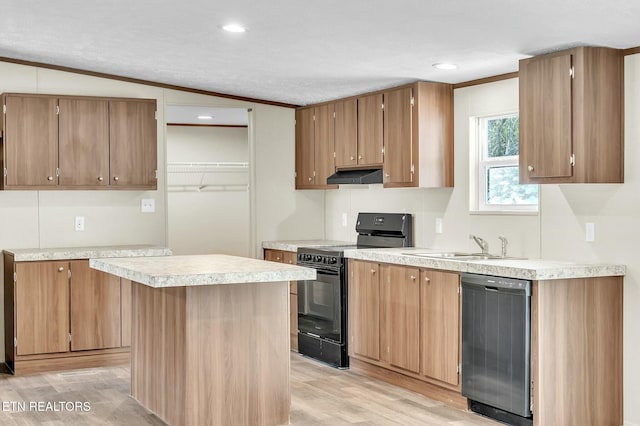 kitchen featuring sink, vaulted ceiling, light wood-type flooring, a kitchen island, and black appliances