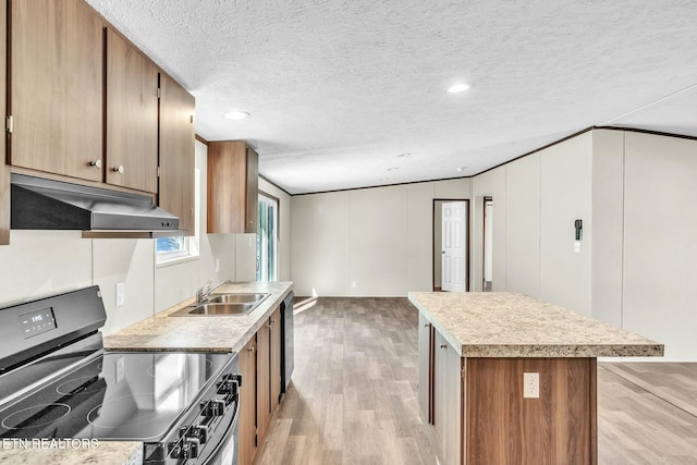 kitchen featuring range with electric cooktop, a kitchen island, sink, a textured ceiling, and light hardwood / wood-style flooring