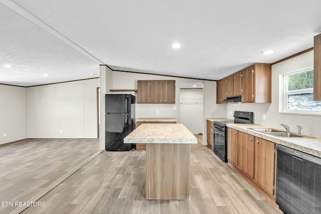 kitchen with sink, crown molding, a center island, a textured ceiling, and black appliances