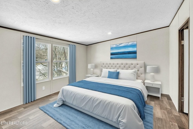 bedroom with hardwood / wood-style flooring and a textured ceiling