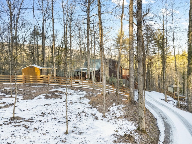 snowy yard featuring an outdoor structure