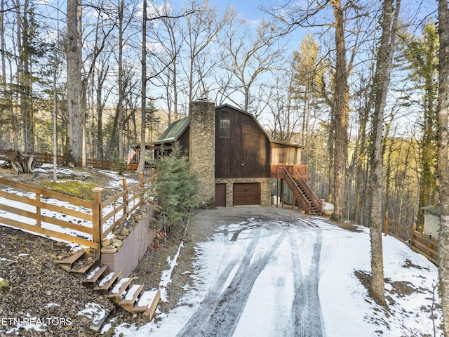 snow covered property featuring a garage