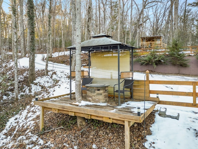 snow covered deck with a gazebo and an outdoor fire pit