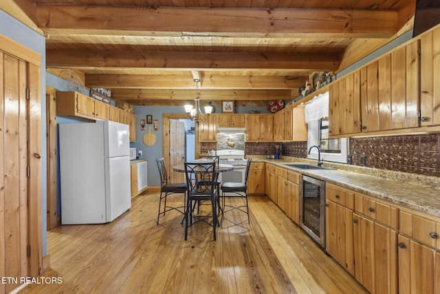 kitchen featuring backsplash, sink, white appliances, wine cooler, and beamed ceiling