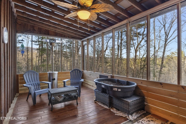 sunroom / solarium featuring ceiling fan and lofted ceiling