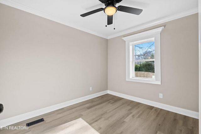 spare room with ornamental molding, light hardwood / wood-style floors, and ceiling fan