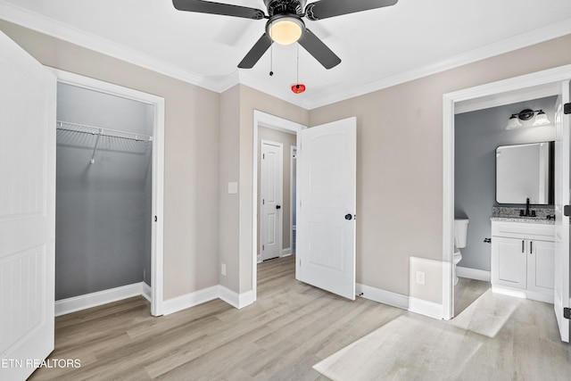 bedroom with sink, connected bathroom, ornamental molding, light hardwood / wood-style floors, and a closet