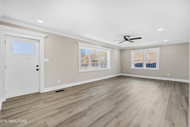 foyer entrance with ornamental molding, ceiling fan, and light wood-type flooring