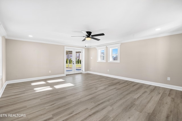 spare room with light hardwood / wood-style flooring, ornamental molding, and french doors