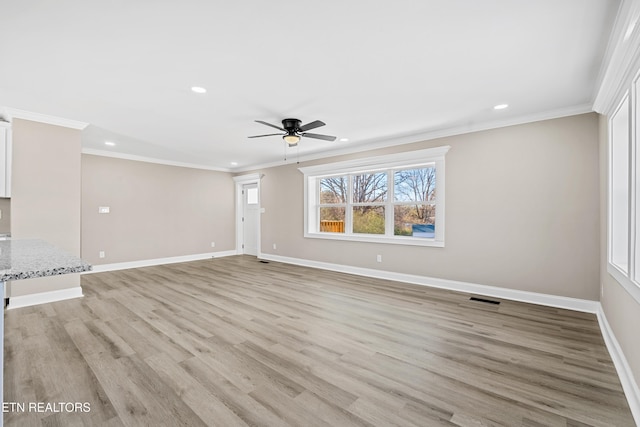 empty room featuring ceiling fan, ornamental molding, and light hardwood / wood-style flooring