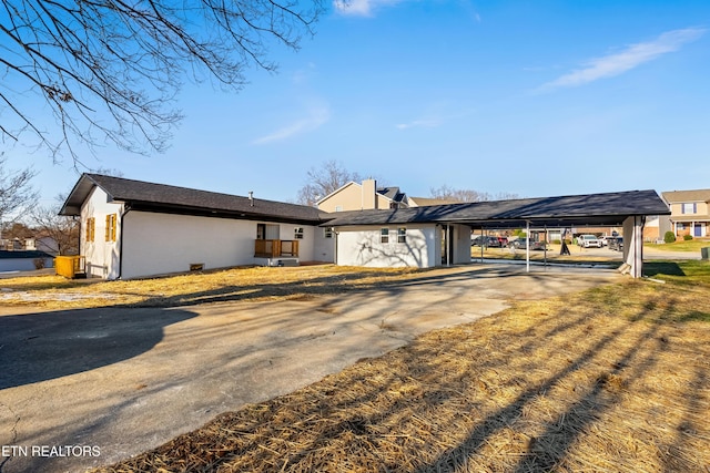 ranch-style home featuring a carport