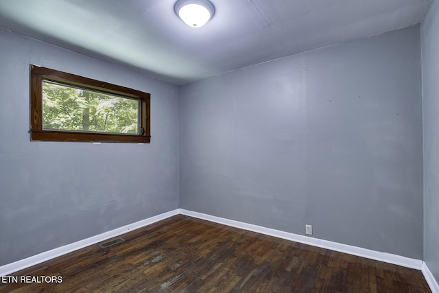 unfurnished room featuring dark hardwood / wood-style floors