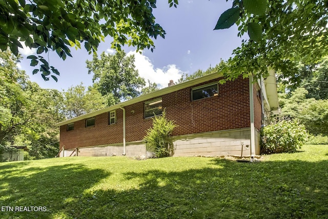 view of home's exterior with a yard