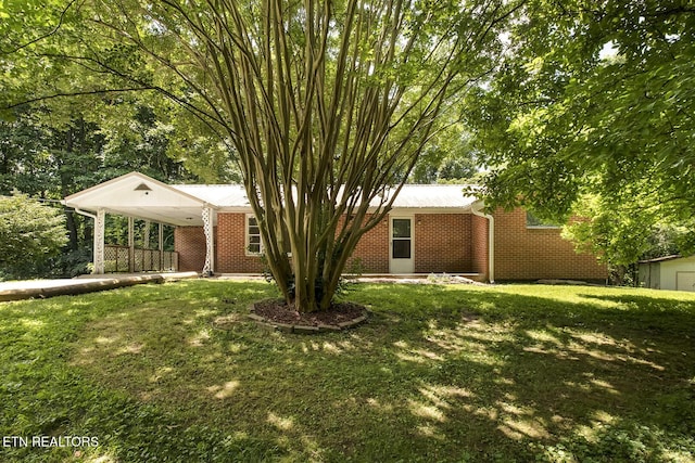 ranch-style house with a front lawn and a carport