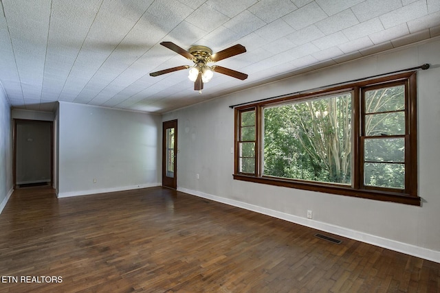 spare room featuring ceiling fan and dark hardwood / wood-style flooring